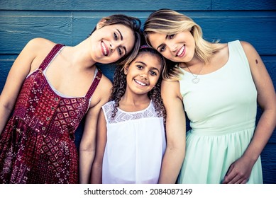 Happy LGBT couple spending time together with their adopted daughter. Cinematic image of a young modern  californian family spending time outdoor in santa monica