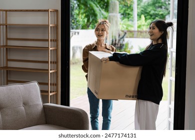 Happy LGBT lesbian Couple Moving into New Home with Cardboard Boxes and Smiling Faces, Embracing New Beginnings and Fresh Start - Powered by Shutterstock