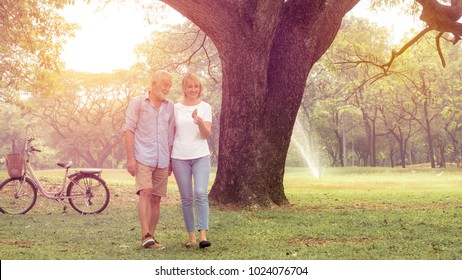 Happy Life, Family, Age, Old Age, Relationship And People Concept - Senior Couple Hugging In City Park