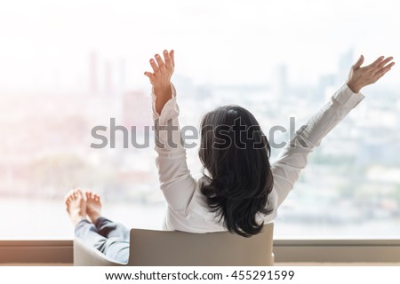 Happy life-work balance of business Asian woman relaxing in hotel living room