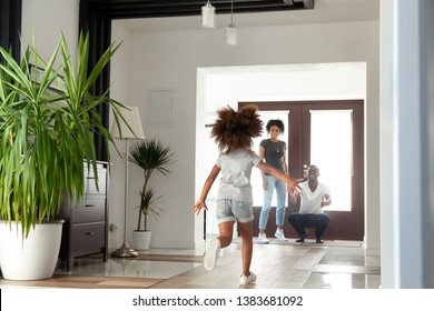 Happy Little African American Girl Run To Dad Excited To Meet Him After Work, Funny Small Child Rush To Black Young Father Return Home After Business Trip, Daddy Wait To Hug Child In Hallway