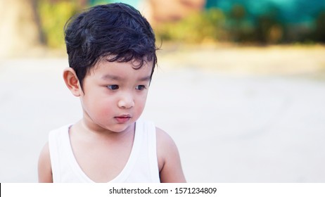 Happy Little Asian Baby Boy 2 Years Old. Child Healthy Happy Funny Smiling Face Young Toddler Lovely Kid Concept. Asian Do Not Looking At Camera Portrait.                                              