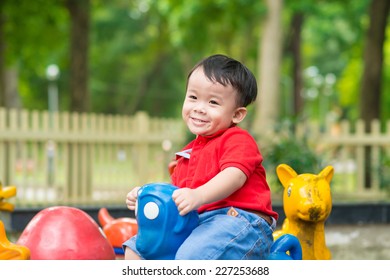 Happy Little Asian Boy, Elementary Aged Child In The Garden Playground In The Park 