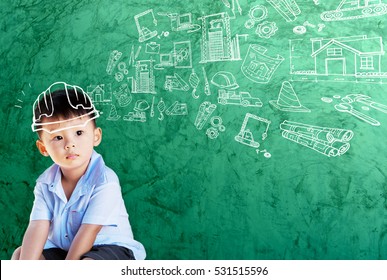 Happy Little Asian Boy Kid In Hard Hat Doodle Chalk Drawing With Sketching Of Building Icon Construction On School Green Chalkboard Background