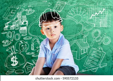 Happy Little Asian Boy Kid In Hard Hat Doodle Chalk Drawing With Sketching Of Building Icon Real Estate On School Green Chalkboard Background