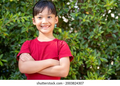 Happy Little Asian Girl Child Showing Front Teeth With Big Smile And Laughing: Healthy Happy Funny Smiling Face Young Adorable Lovely Female Kid.Joyful Portrait Of Asian Elementary School Student.