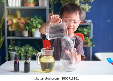 Happy Little Asian School Kid Studying Science, Making DIY Lava Lamp Science Experiment With Oil, Water And Food Coloring, Kid-friendly Fun And Easy Science Experiments At Home Concept