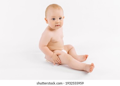 Happy Little Baby In Diaper Sitting On Isolated White Background