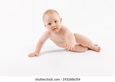 Happy little baby in diaper sitting on isolated white background