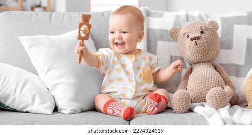Happy little baby with toys at home