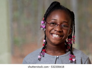 A happy little black girl smiling - Powered by Shutterstock