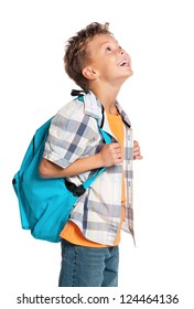Happy little boy with backpack looks into up isolated on white background