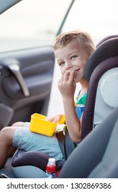 Happy Little Boy In The Car Eating Cookies