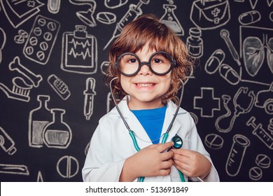 Happy Little Boy In Doctor Costume Holding Sthetoscope On Dark Background With Pattern. The Child Has Glasses