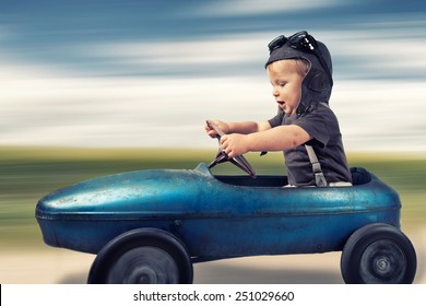 Happy Little Boy Driving Big Vintage Old Toy Car And Having Fun, Outdoors. Kids Leisure On Summer Day