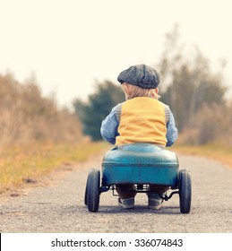 Happy Little Boy Driving Big Vintage Old Toy Car And Having Fun, Outdoors. Kid Leisure On Autumn Day