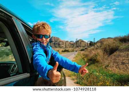 happy little boy enjoy travel by car in nature