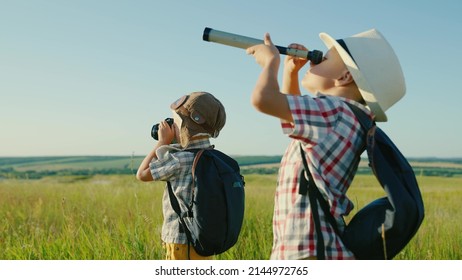 Happy Little Boy Friends Playing In Summer West Park, Looking Through Spyglass Dream Fly Travel. Kids Son Of Traveler, Dreams Of Discoveries. Children's Friendship. Leader Winner, Travel, Nature