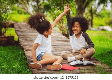 Happy Little Boy And Girl In The Park. Two African American Children Together In The Garden.