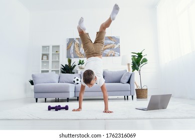 Happy little boy gymnastic acrobatics equilibrium posture isolated on white background