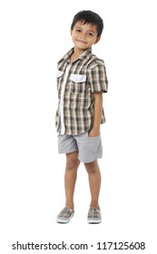 Happy Little Boy With Hands In Pockets On White Background