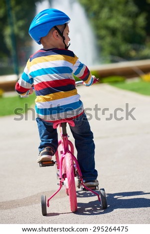 Similar – A funny boy riding his bicycle