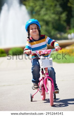 Similar – A funny boy riding his bicycle