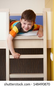 Happy Little Boy Having Fun On Bunk Bed, Laughing.