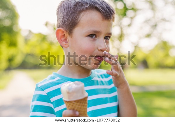 Happy Little Boy Licks His Finger Stock Photo (Edit Now) 1079778032