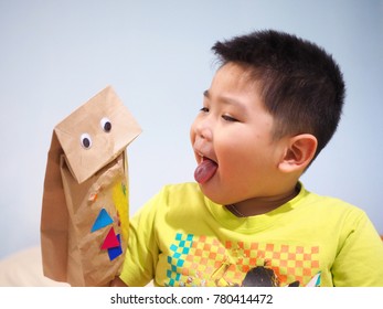 Happy Little Boy Playing With Paper Hand Puppet At Home.    