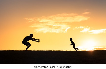 Happy Little Boy Running To His Fathers Arms. Childhood And Parenting. Parent Child Relationship Concept. 