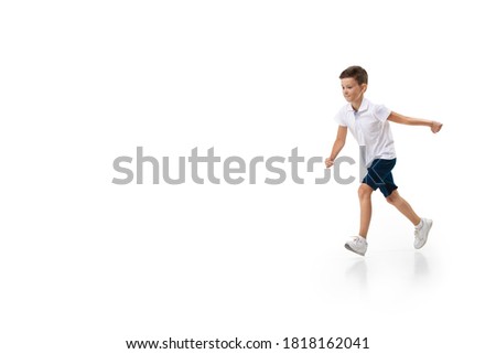 Happy little boy running on white background, happiness