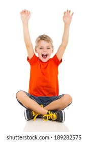 Happy Little Boy Sitting On Floor And Arms Up