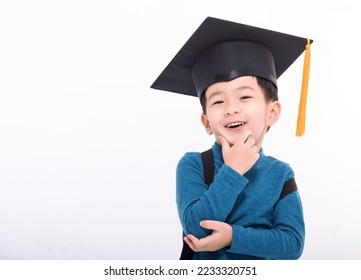 Happy little boy student in a graduate cap thinking and looking at camera - Powered by Shutterstock