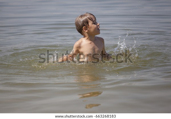 boy swimming in river