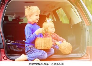 happy little boy and toddler girl travel by car