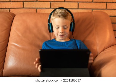 Happy little boy watching videos - Powered by Shutterstock