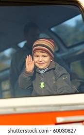 Happy Little Boy Waving Hand, Through The Window View.