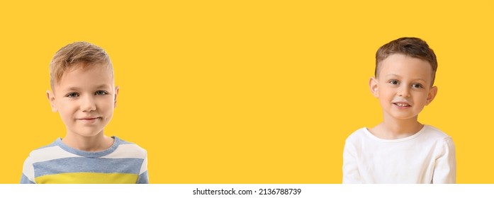 Happy little boys on yellow background with space for text