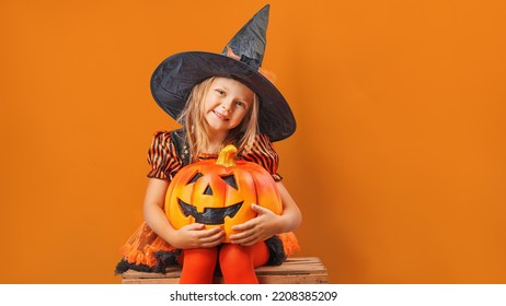  Happy Little Child Girl In Witch Costumes And Makeup Having Fun On Halloween Celebration