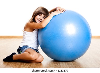 Happy Little Child Playing With A Big Blue Ball