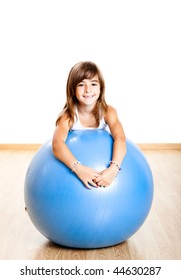 Happy Little Child Playing With A Big Blue Ball