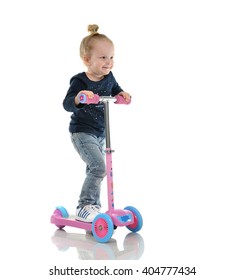 Happy Little Child Toddler Girl Learning To Ride And Balance On Push Three Wheel Adjustable Height Scooter Isolated On A White Background