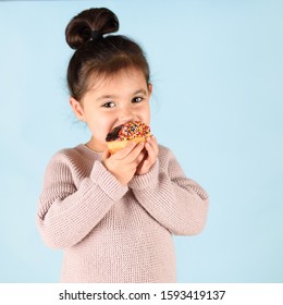 Happy Little Cute Child Holding Donut And Eating.