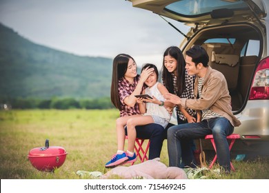 Happy Little Girl  With Asian Family Sitting In The Car For Enjoying Road Trip And Summer Vacation In Camper Van