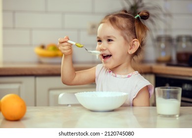 Happy little girl child 2-3 years old eats healthy food at home or in kindergarten. - Powered by Shutterstock