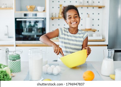 Happy Little Girl Cooking At Home