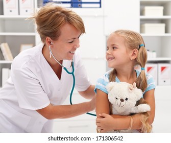 Happy Little Girl At The Doctor For A Checkup - Being Examined With A Stethoscope