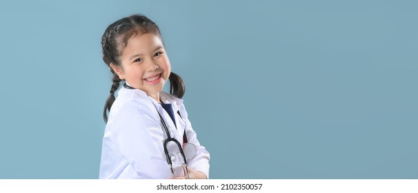 Happy Little Girl  In Doctor Coat With Stethoscope. Child Playing. Future Occupation Or Dream Job Concept. Happy Children's Day.