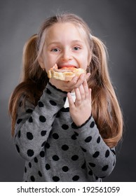 Happy Little Girl Eating Bread And Butter With Fish And Showing Yes Sign On A Gray Background